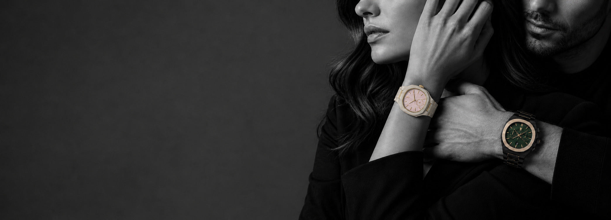 Two people wearing watches with a dark background