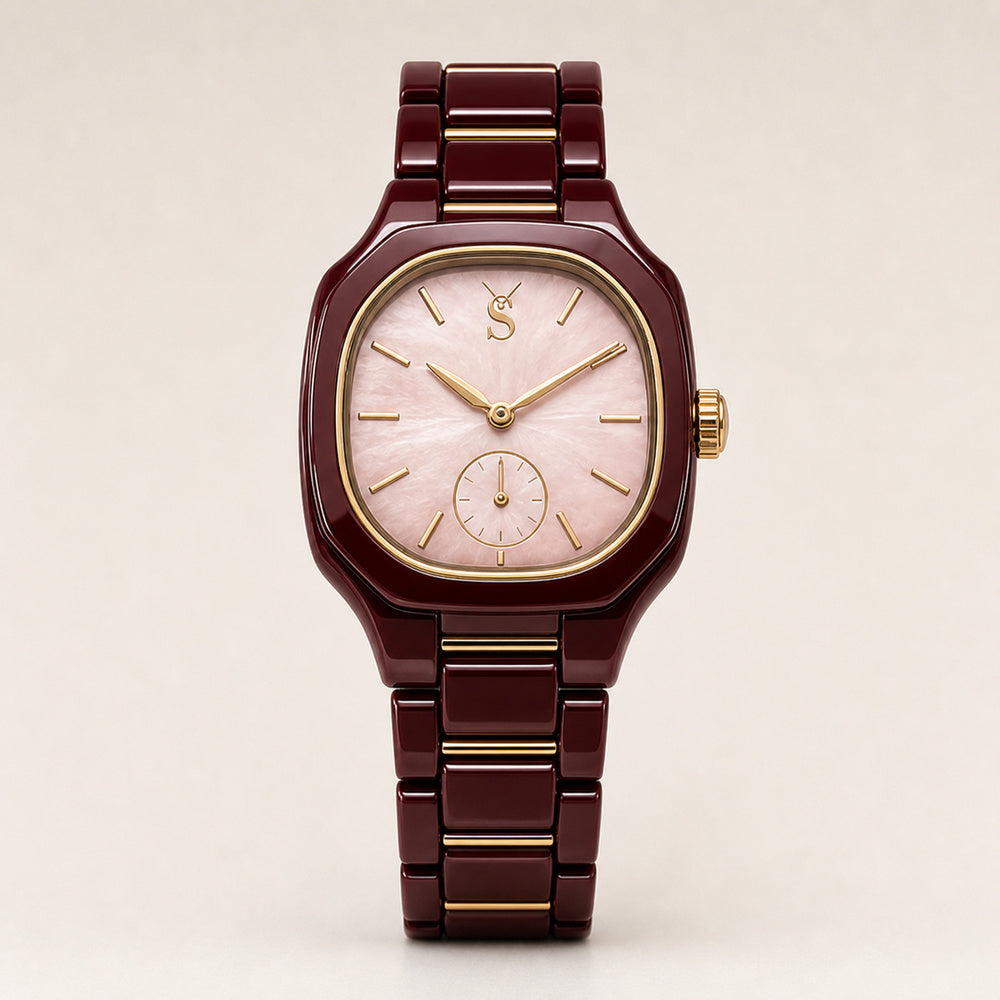 Watch with a maroon strap and gold accents on a beige background