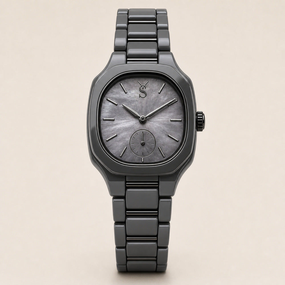 Gray wristwatch with a detailed face on a beige background