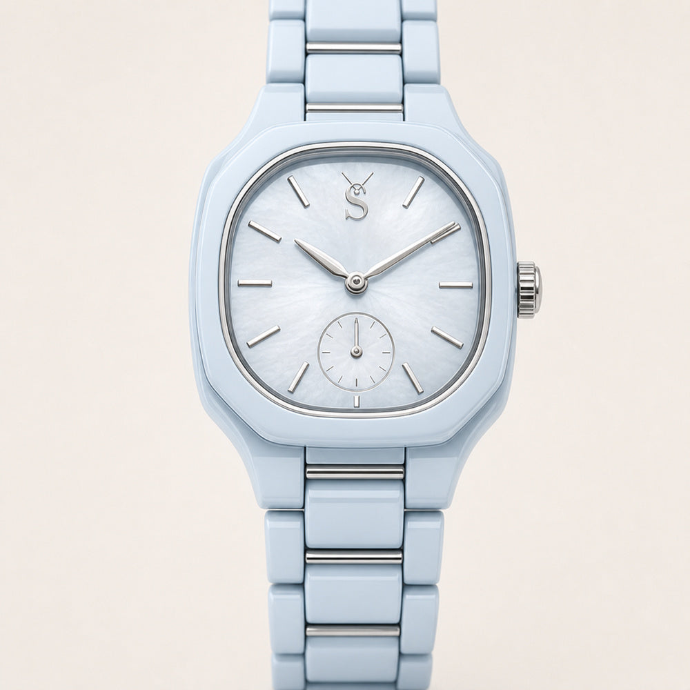 Light blue watch with a matching band on a beige background