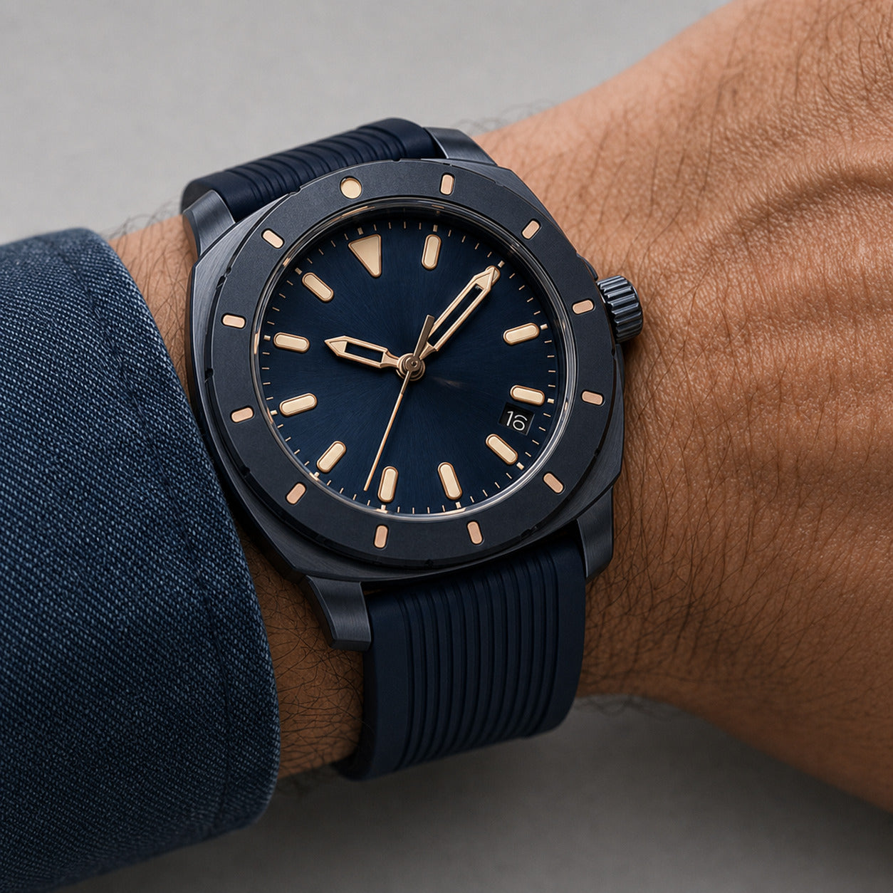 Blue watch with gold accents on a wrist against a gray background