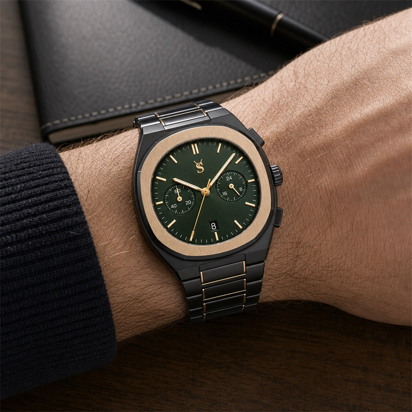 Luxury watch with a green dial on a person's wrist, with a blurred background