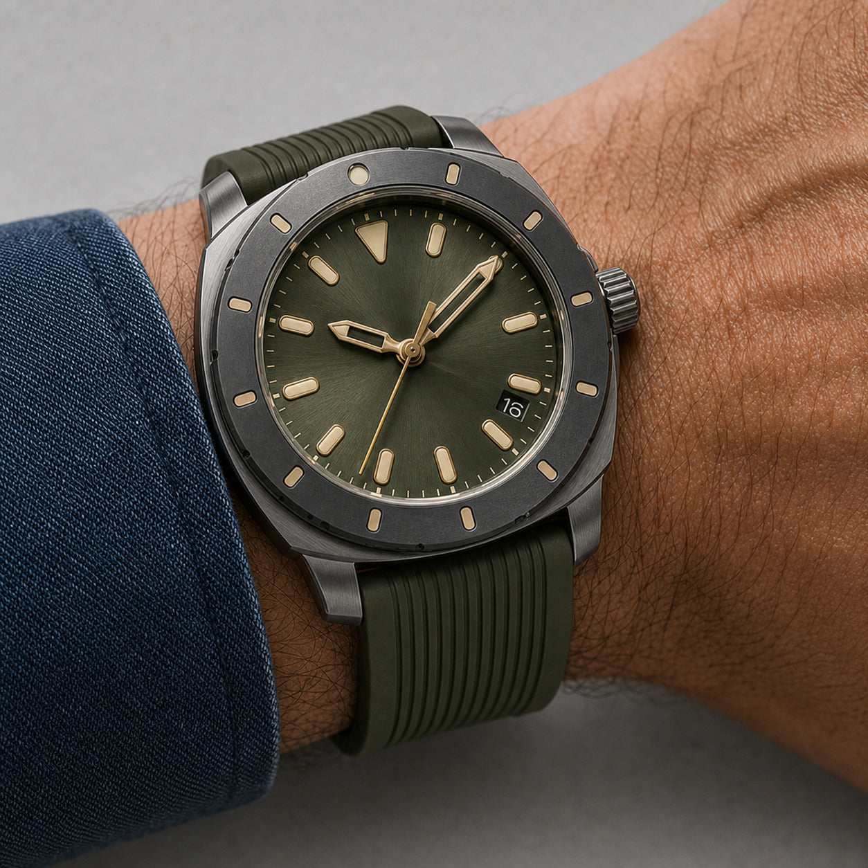 Wristwatch with green strap and dark green face on a wrist, against a neutral background
