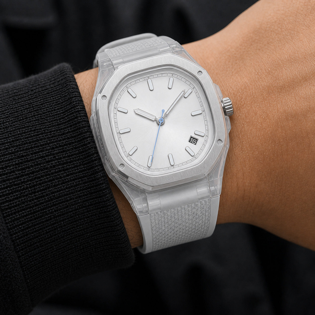 Silver watch on a wrist with a black background
