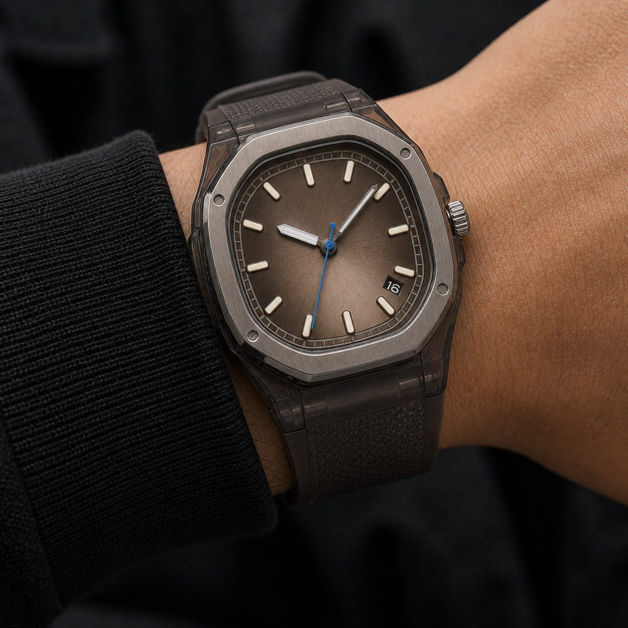 Luxury watch on a person's wrist with a dark strap and brown dial.
