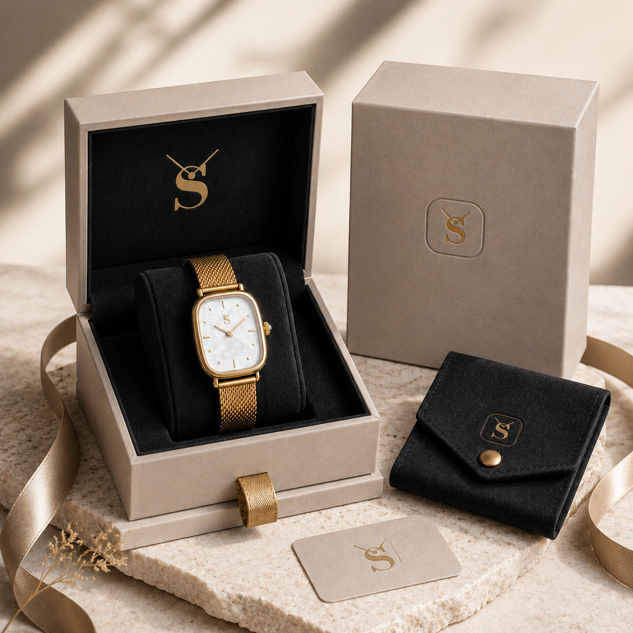 Gift for her premium watch box set. Featuring an elegant women's gold mesh watch with a vintage oval case and mother of pearl dial, packaged in a beautiful beige presentation box with a suede pouch