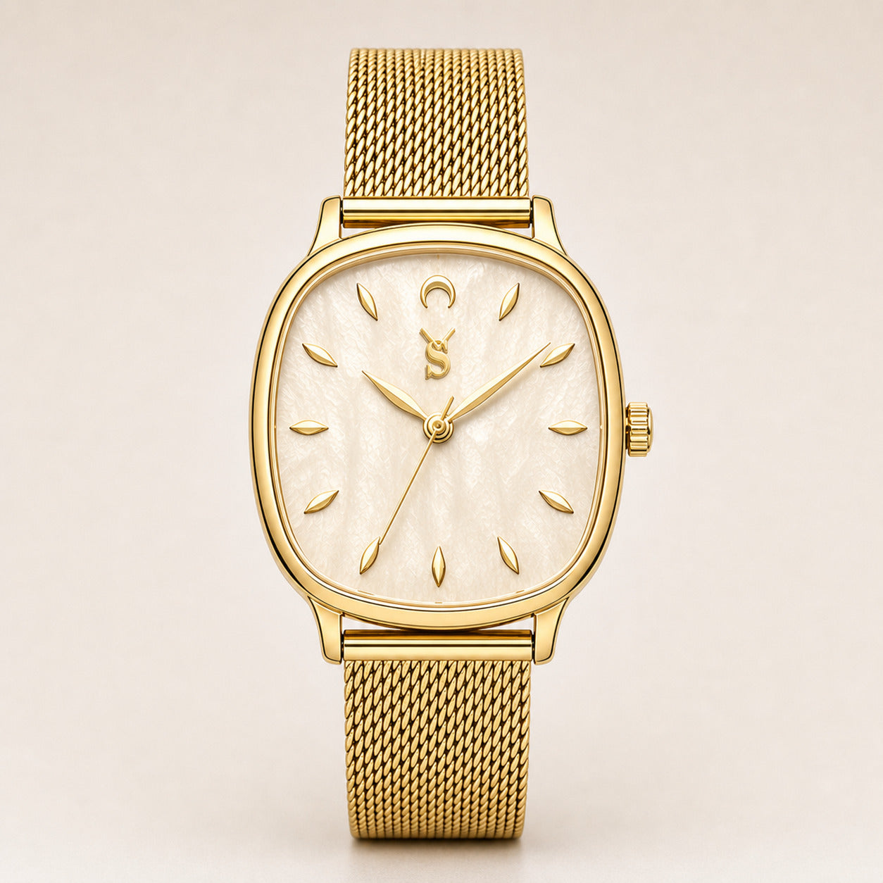 Gold watch with a mesh band on a beige background