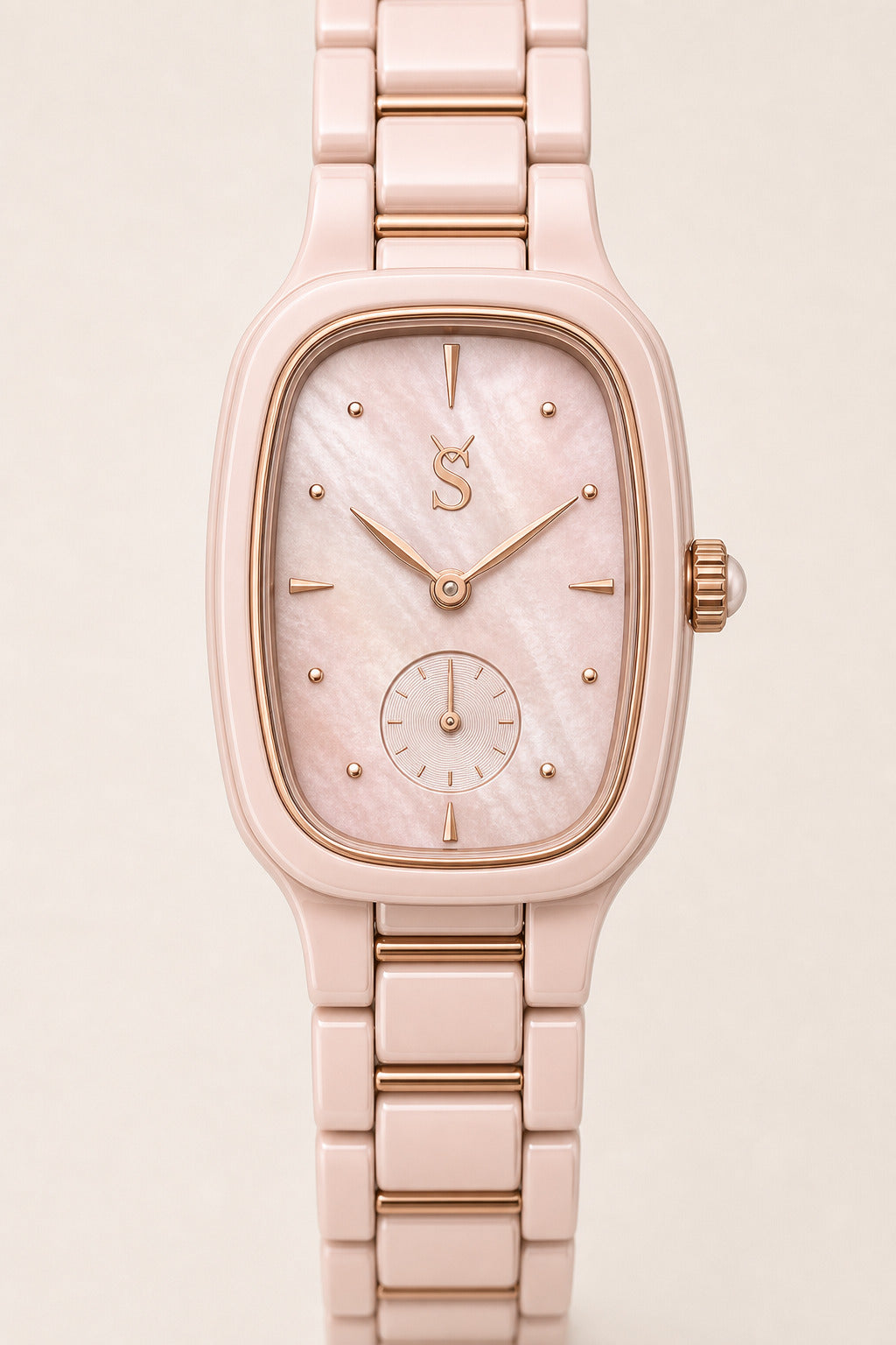 Rose gold watch with a light pink face on a beige background