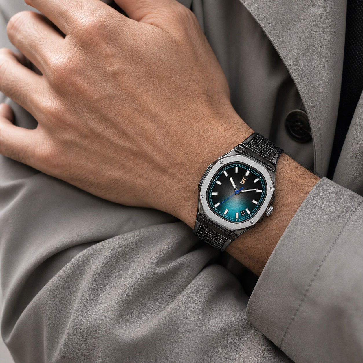 Close-up of a wrist wearing a watch with a blue face, set against a neutral background.
